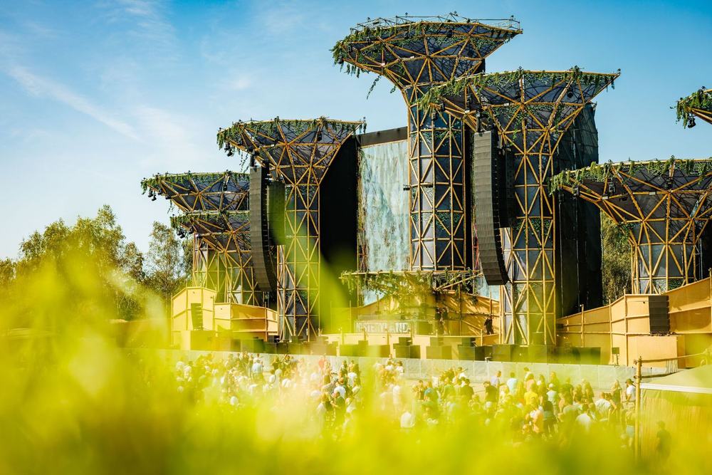 Mysteryland stage with tall tower structures in a green field